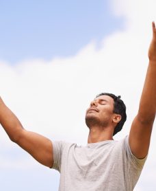 Embrace the day. Shot of a man with his arms outstretched to the sky